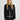 Woman wearing a black jacket with button details on a white background