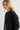 Woman wearing a black jacket on a plain background