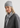 Woman wearing a gray knit hat and scarf with a plain background