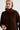Woman wearing a brown sweater against a white background