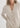 Woman wearing a beige cardigan against a white background