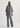 Person wearing a gray outfit on a white background