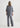 Person wearing a gray outfit on a white background