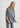 Woman wearing a gray outfit on a white background