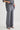 Person wearing gray wide-leg pants and a matching top on a light background
