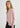 pink cashmere crewneck cardigan worn with grey wide leg pants