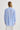 Person wearing a blue and white striped shirt on a plain background