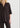 Woman wearing a dark brown outfit on a white background