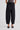 Woman wearing black barrel leg pants