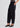 Woman wearing black barrel leg pants