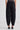 Woman wearing black barrel leg pants