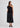 Woman wearing black top and skirt