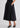 Woman wearing black top and skirt