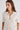 Woman in cream cashmere polo shirt