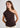 Woman wearing brown one shoulder top
