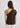 Woman wearing brown one shoulder top